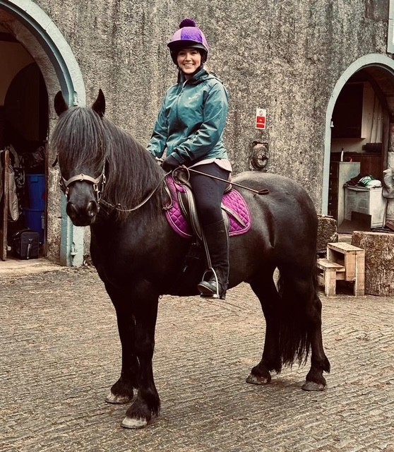 black pony with a rider side view