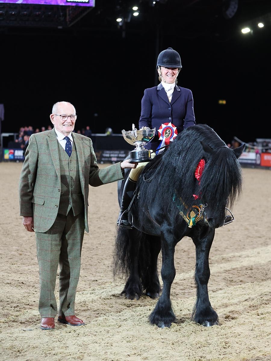 black pony with a rider, receiving award in the arena of the Horse of the Year Show