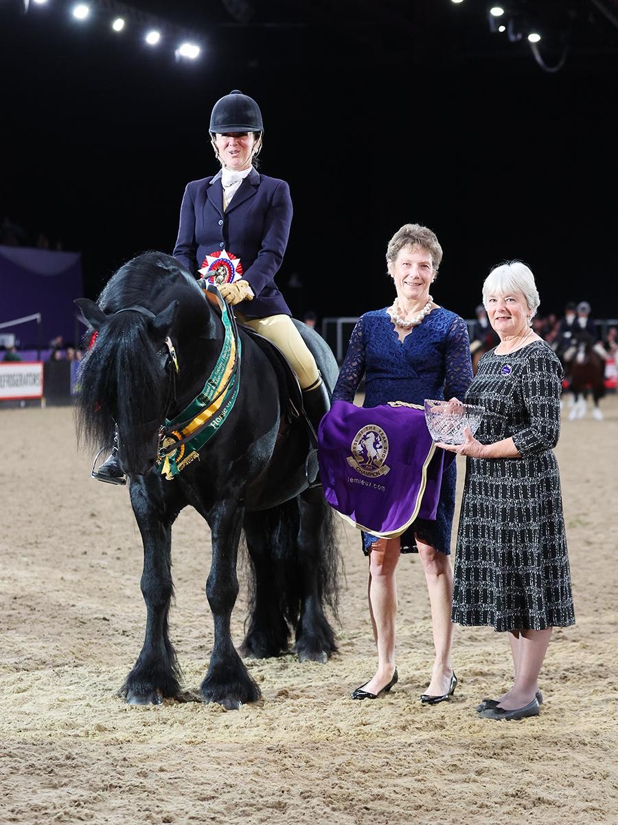 black pony with a rider, receiving award in the arena of the Horse of the Year Show